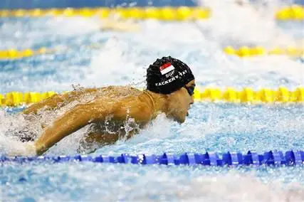 A Temasek Polytechnic student is pictured competing in a swimming competition, symbolising student ambition and talent.