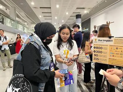 A student from Temasek Polytechnic promotes her organisation, “You(th) Can Do It”, at a roadshow, symbolising youth volunteerism and agentic community uplift. Caption: Ayuni highlights the shortage of youth volunteers compared to adults and urges her generation to serve as beacons of hope to others in the community.