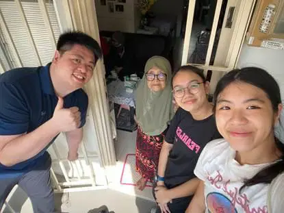 A student from Temasek Polytechnic poses with her care beneficiary and caregiving partners, symbolising passionate community volunteerism. Caption: Ayuni Nur Izyanti is galvanising a new wave of youth-driven community empowerment, inspiring hands-on, compassionate care in Singapore.