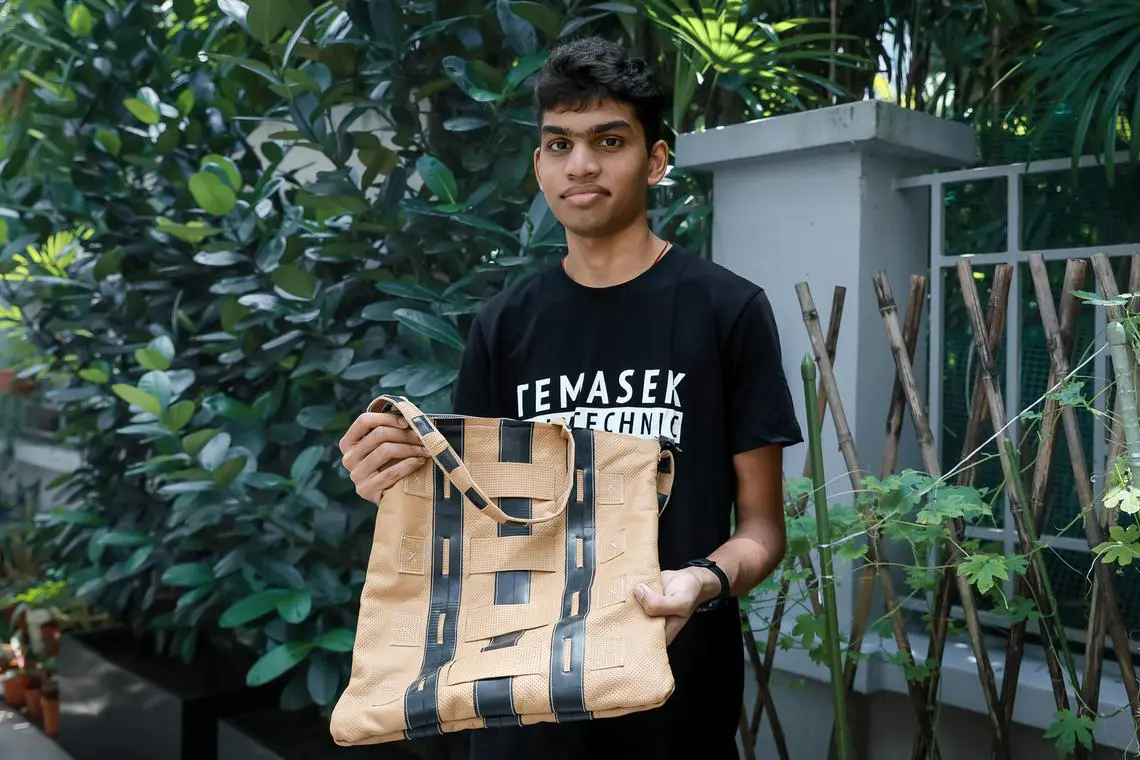 A Temasek Polytechnic student holds an eco-friendly bag he designed for PWDs, symbolising a drive for inclusive, sustainable change supported by TP.