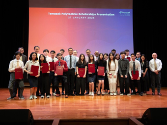 Temasek Polytechnic scholarship recipients and staff posing on stage at a scholarship presentation ceremony, with students holding red certificate folders.