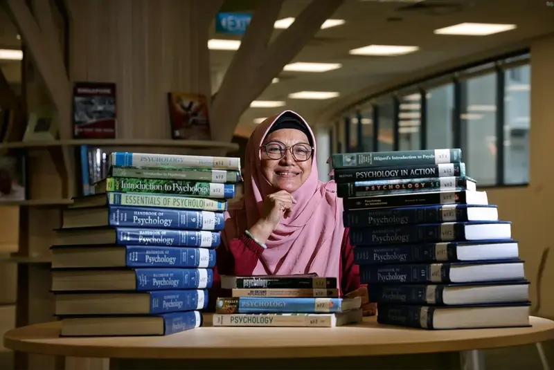Senior learner surrounded by books, showcasing lifelong education, new qualifications, personal growth, and expanded career opportunities.